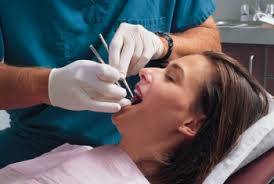 Woman teeth being examined by dentist before tooth taken out