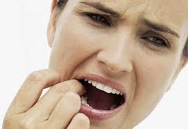 Woman with painful expression touching her molar teeth