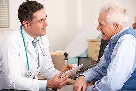 Physician speaks to old man